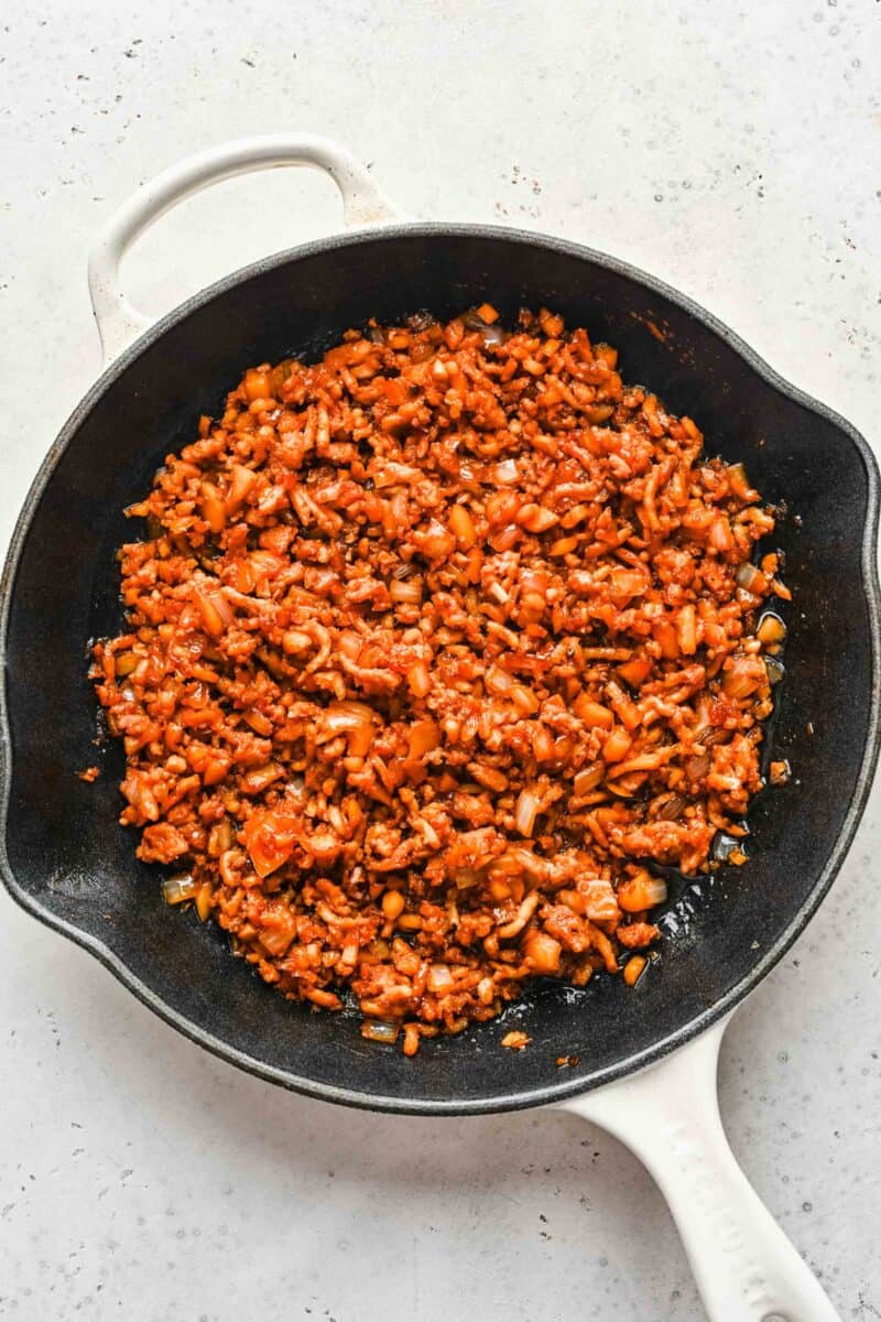 Seasoned chicken for lettuce wraps browned in a skillet.