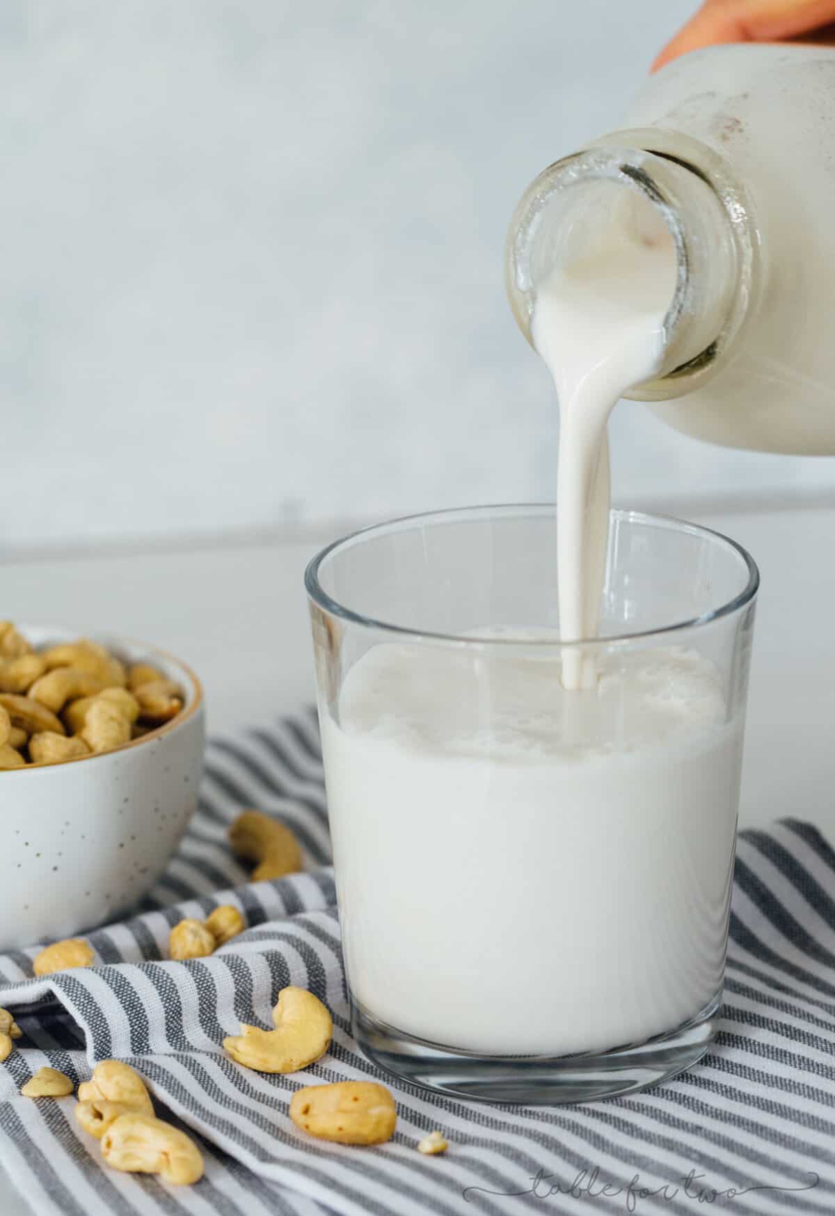 Making your own cashew milk at home is super easy and it seriously tastes so much cleaner and better than the store-bought kind. You know exactly what goes into it — cashews and water — and you can add additional flavors if you desire! #homemadecashewmilk #cashewmilk #cashewbeverage #homemade