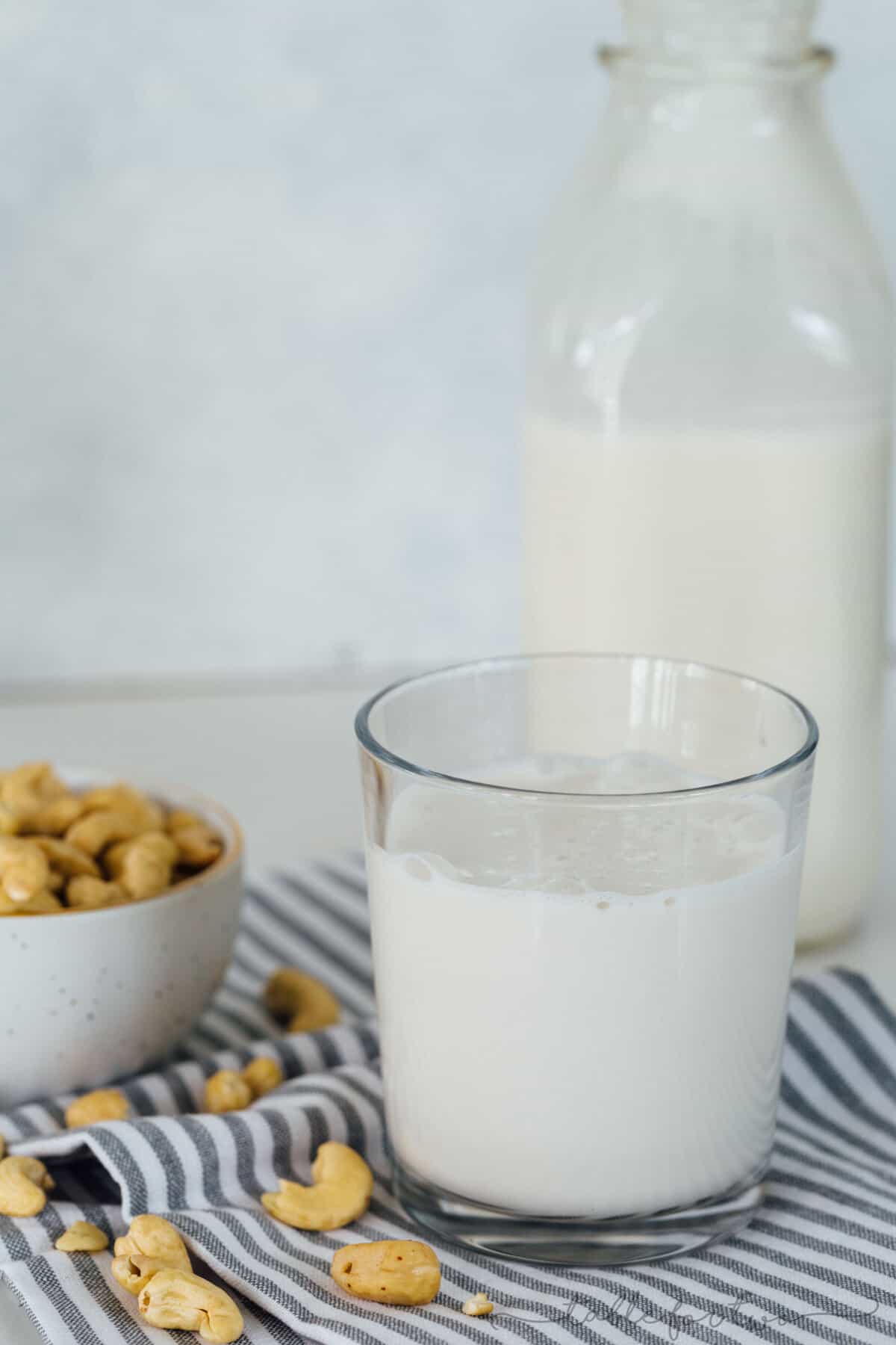 Making your own cashew milk at home is super easy and it seriously tastes so much cleaner and better than the store-bought kind. You know exactly what goes into it — cashews and water — and you can add additional flavors if you desire! #homemadecashewmilk #cashewmilk #cashewbeverage #homemade