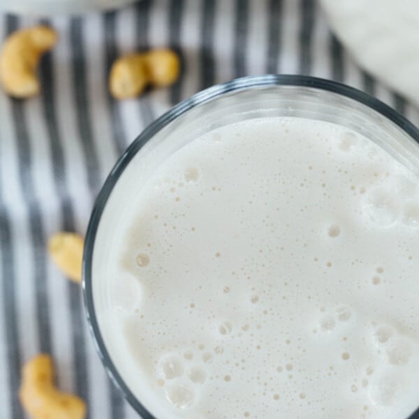 Making your own cashew milk at home is super easy and it seriously tastes so much cleaner and better than the store-bought kind. You know exactly what goes into it — cashews and water — and you can add additional flavors if you desire! #homemadecashewmilk #cashewmilk #cashewbeverage #homemade