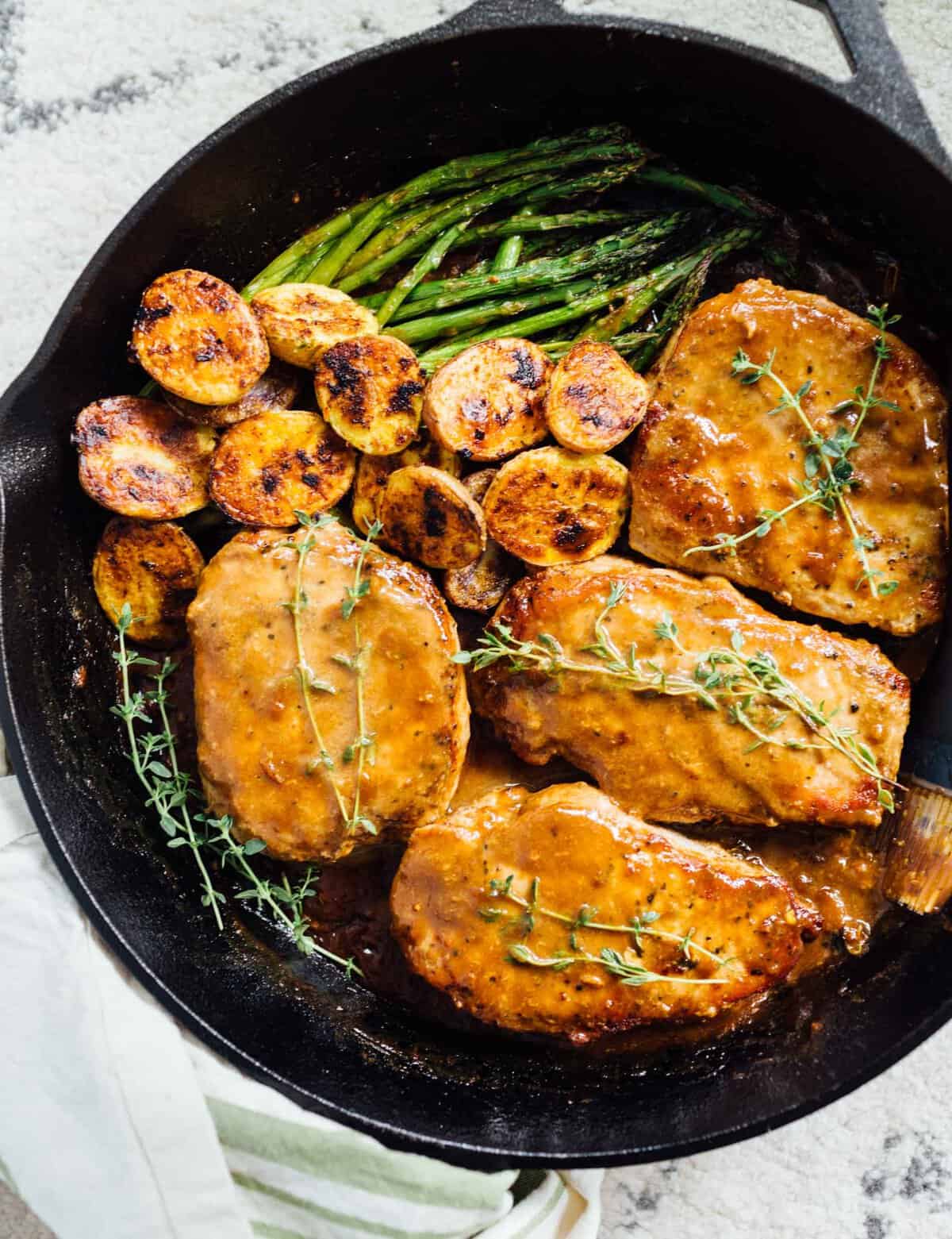 Apricot balsamic pork chops are going to be in your weeknight dinner rotation after your first bite of this sweet and tangy dish! #apricotbalsamic #apricot #porkchops #quickdinner #easydinner #skilletdinner