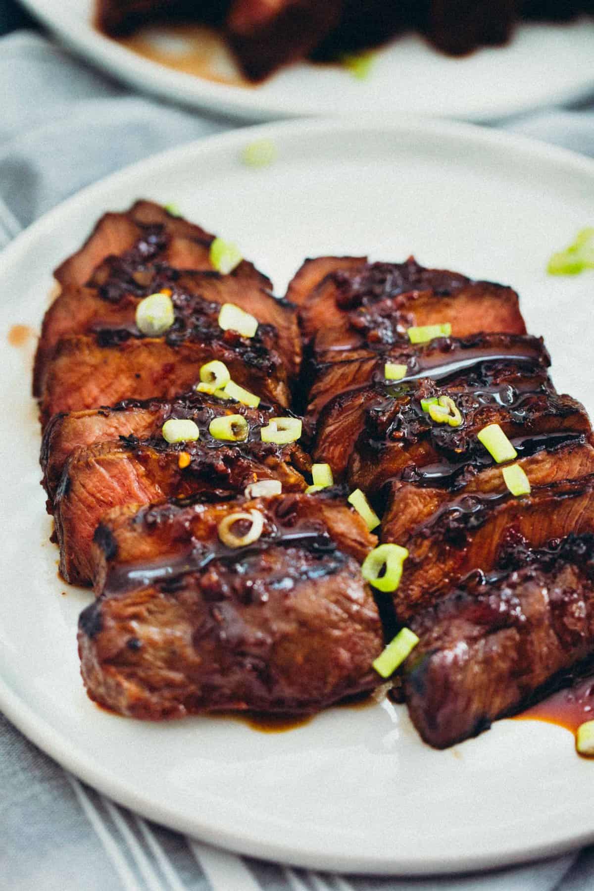 This grilled Asian marinated flat iron steak is a quick weeknight meal when you're looking to change up traditional grilled steak! #grilling #steak #flatironsteak #asianmarinade