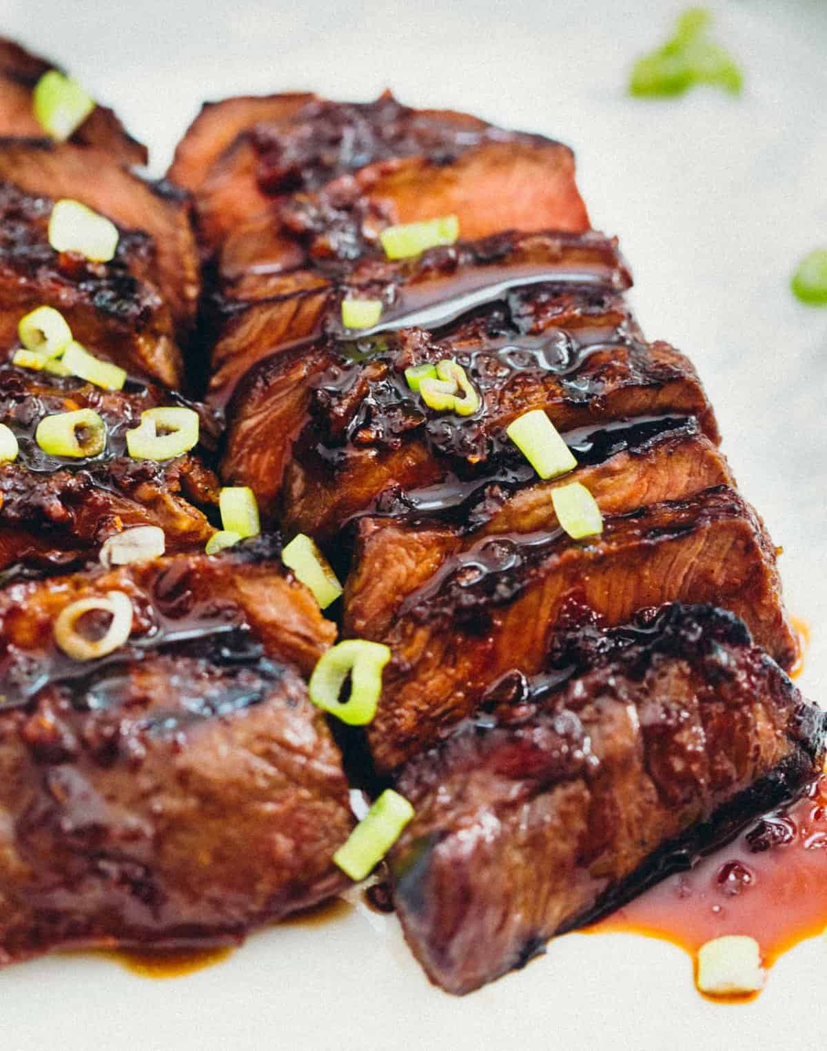 This grilled Asian marinated flat iron steak is a quick weeknight meal when you're looking to change up traditional grilled steak! #grilling #steak #flatironsteak #asianmarinade