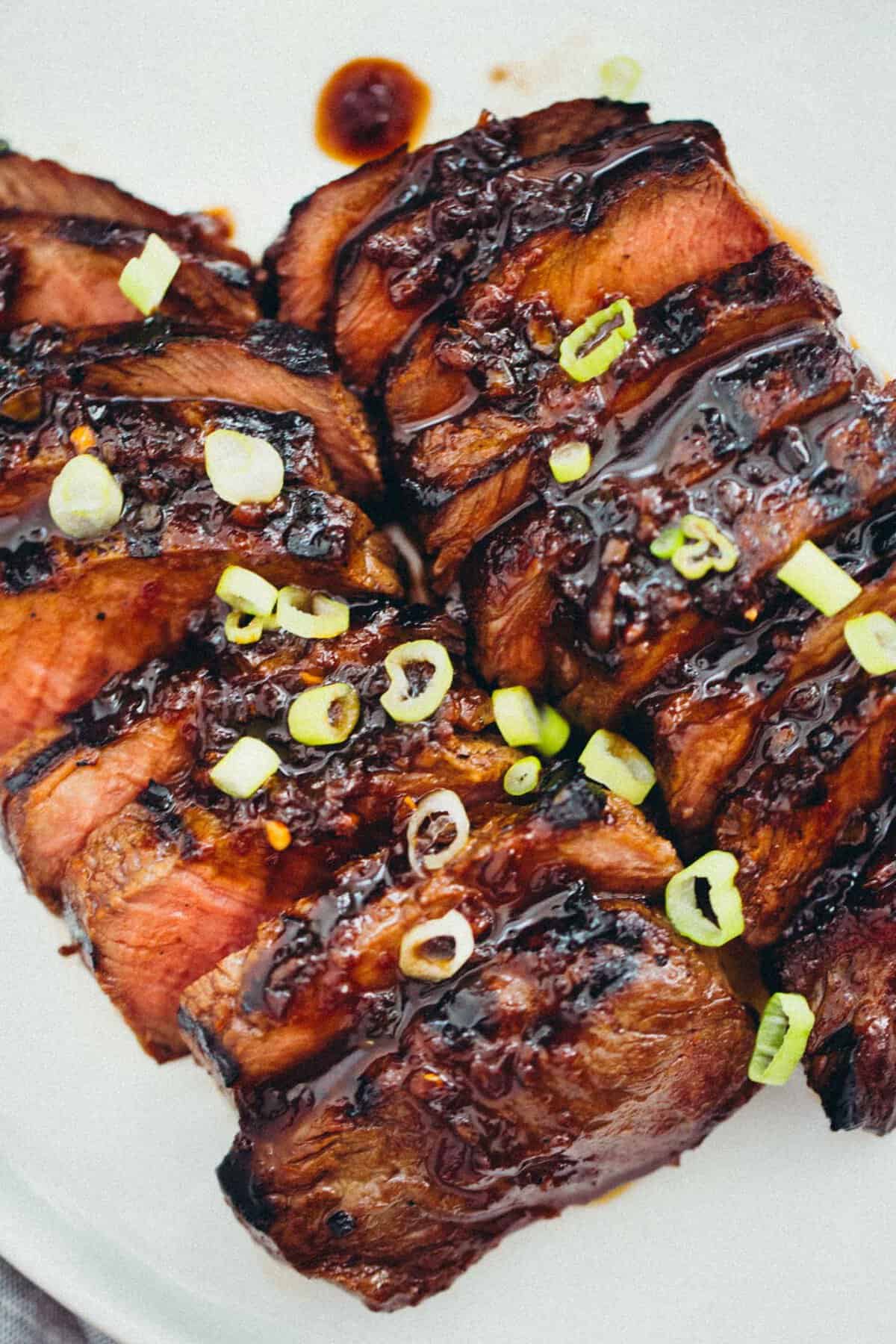 This grilled Asian marinated flat iron steak is a quick weeknight meal when you're looking to change up traditional grilled steak! #grilling #steak #flatironsteak #asianmarinade