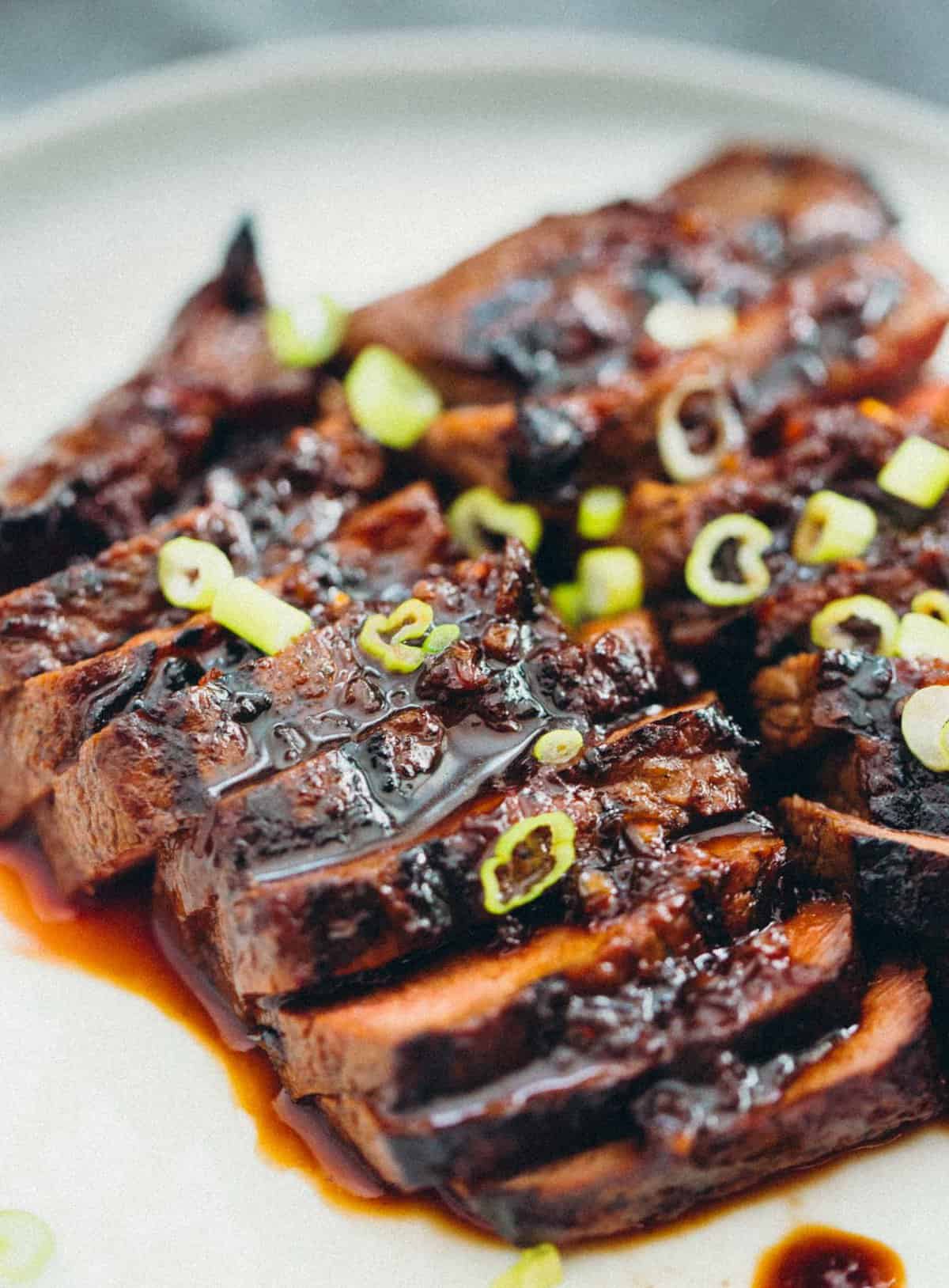 This grilled Asian marinated flat iron steak is a quick weeknight meal when you're looking to change up traditional grilled steak! #grilling #steak #flatironsteak #asianmarinade