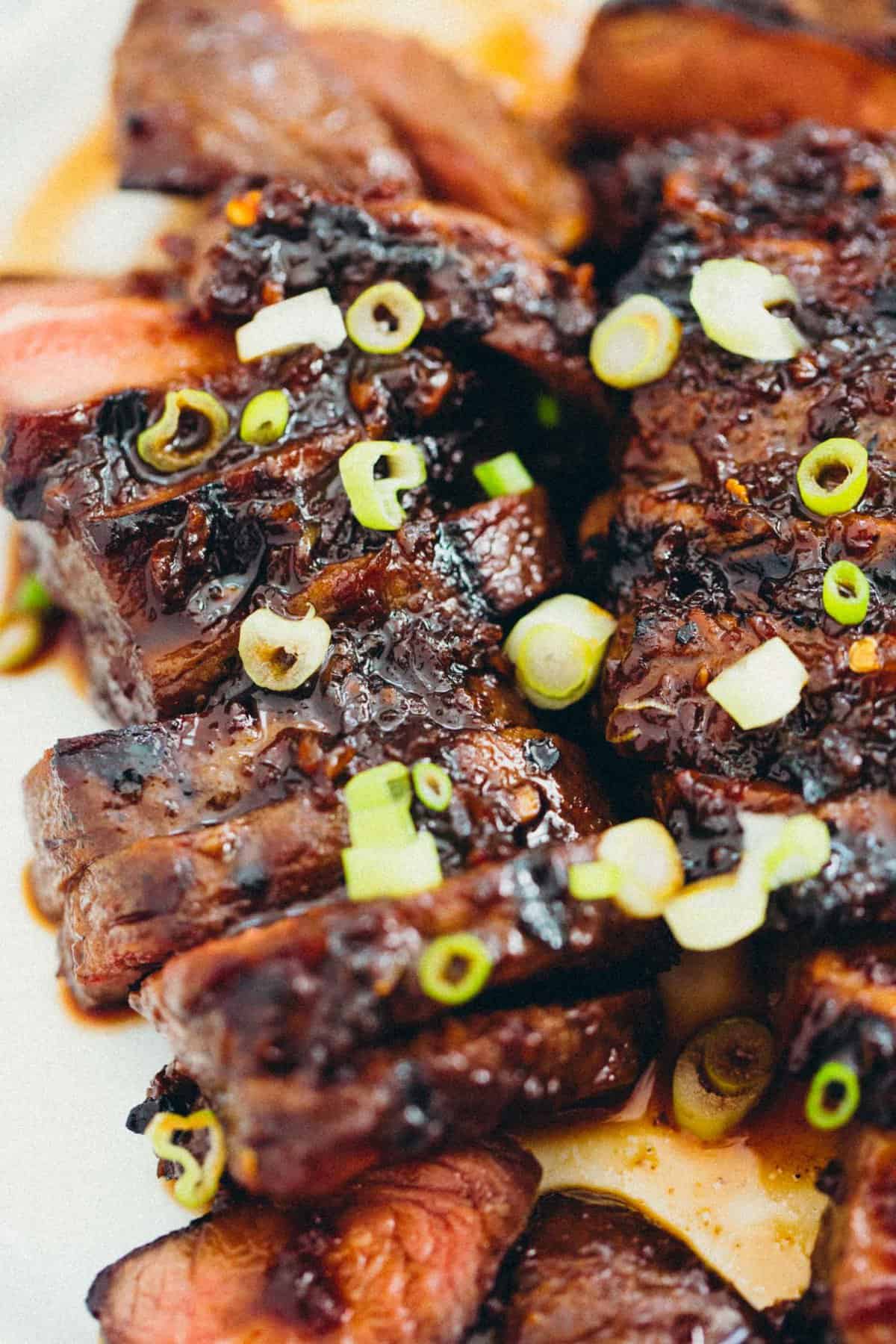 This grilled Asian marinated flat iron steak is a quick weeknight meal when you're looking to change up traditional grilled steak! #grilling #steak #flatironsteak #asianmarinade