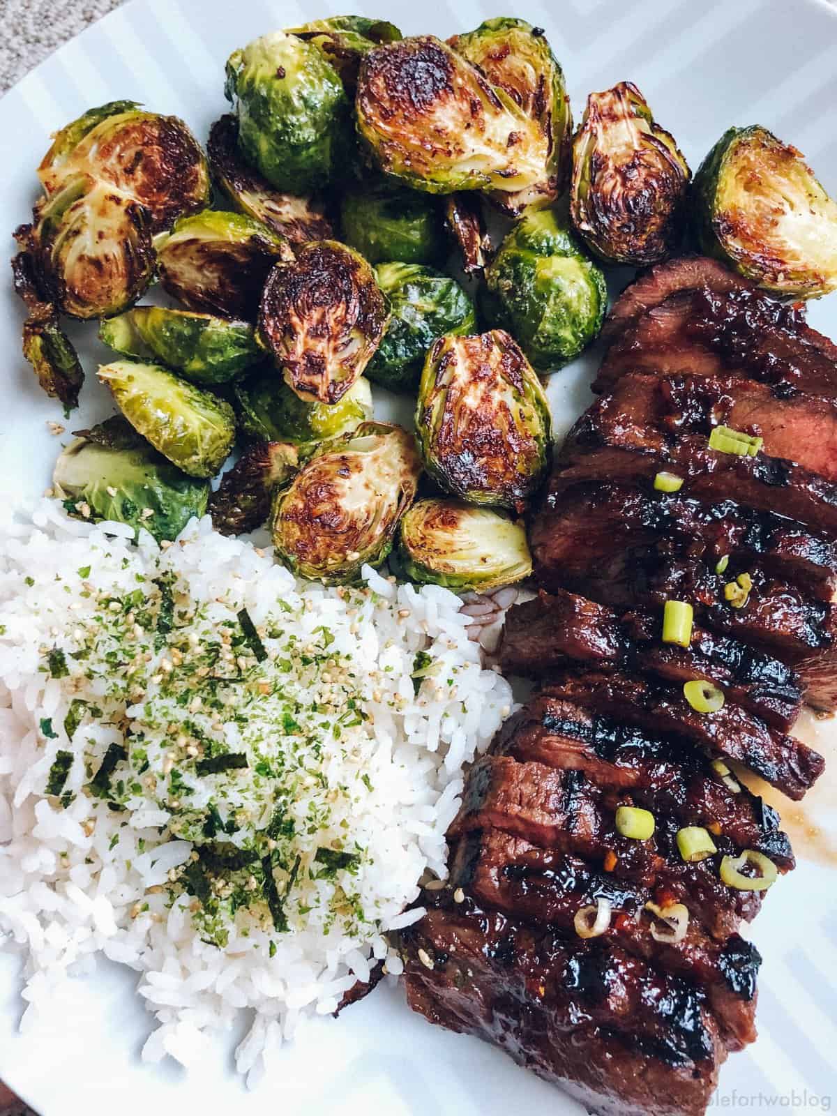 This grilled Asian marinated flat iron steak is a quick weeknight meal when you're looking to change up traditional grilled steak! #grilling #steak #flatironsteak #asianmarinade