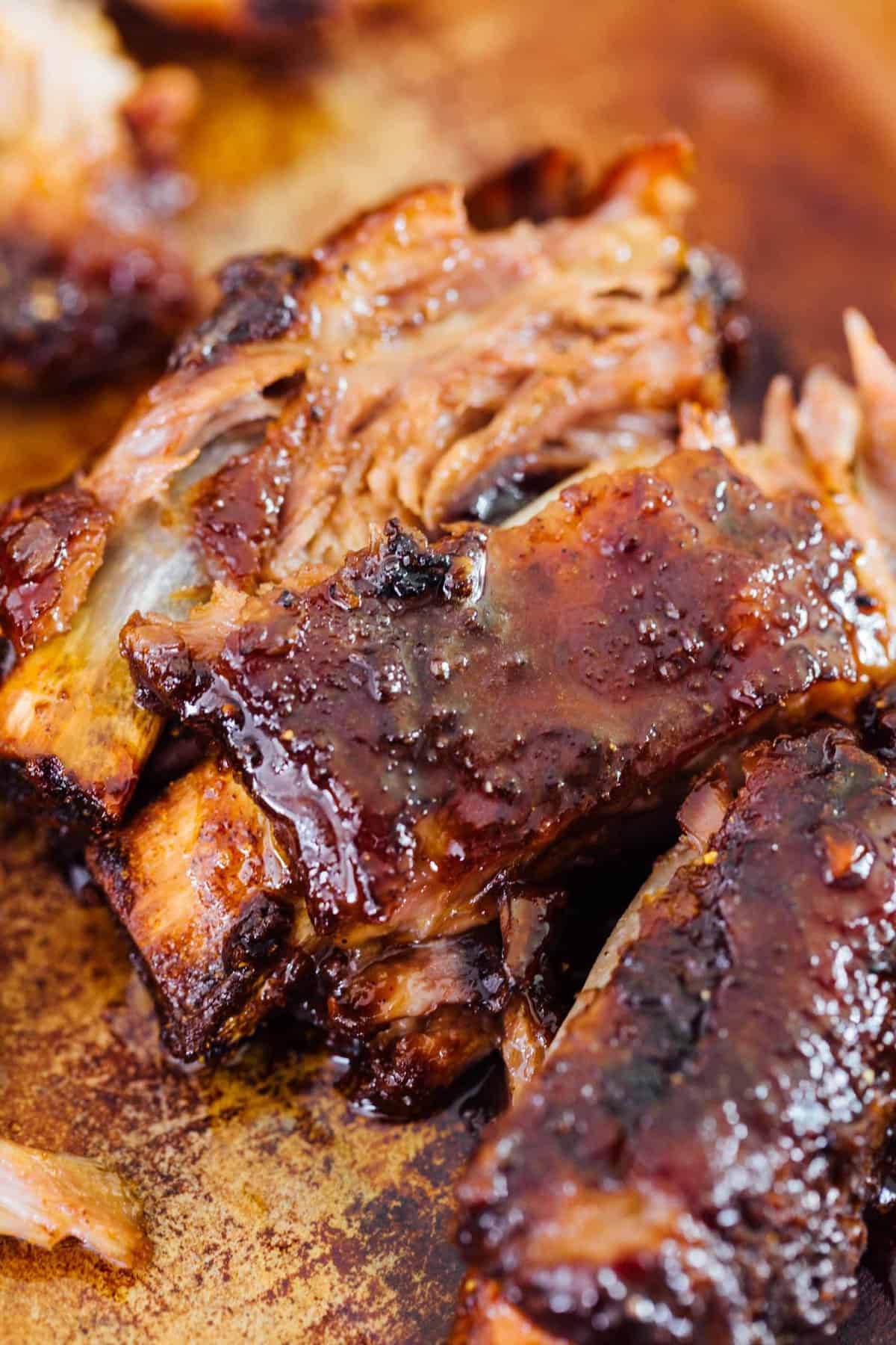 These tender honey butter ribs are oven baked to perfection and they fall off the bone! They are literally bathed in honey, butter, and brown sugar. There is no way you will be able to put this down! #honey #butter #ribs #babybackribs #ovenbaked #pork #porkrecipe