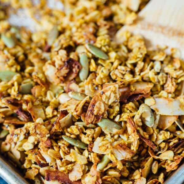 This pumpkin coconut granola has all the flavors of Fall in this sweet and salty combination! It's perfect to top on plain yogurt, oats, or even with milk! #granola #pumpkincoconut #coconut #pumpkinrecipe #granolarecipe