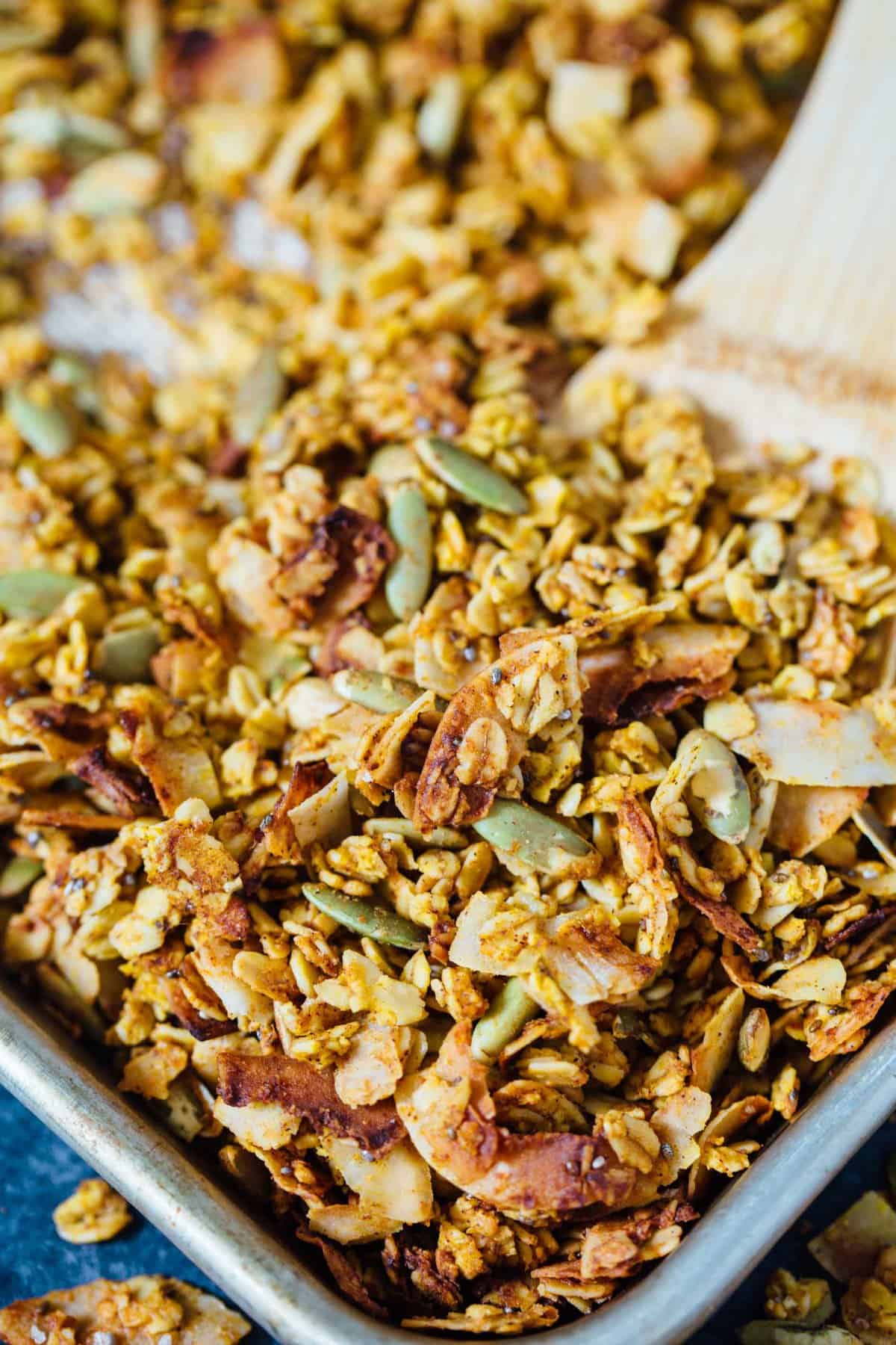 This pumpkin coconut granola has all the flavors of Fall in this sweet and salty combination! It's perfect to top on plain yogurt, oats, or even with milk! #granola #pumpkincoconut #coconut #pumpkinrecipe #granolarecipe