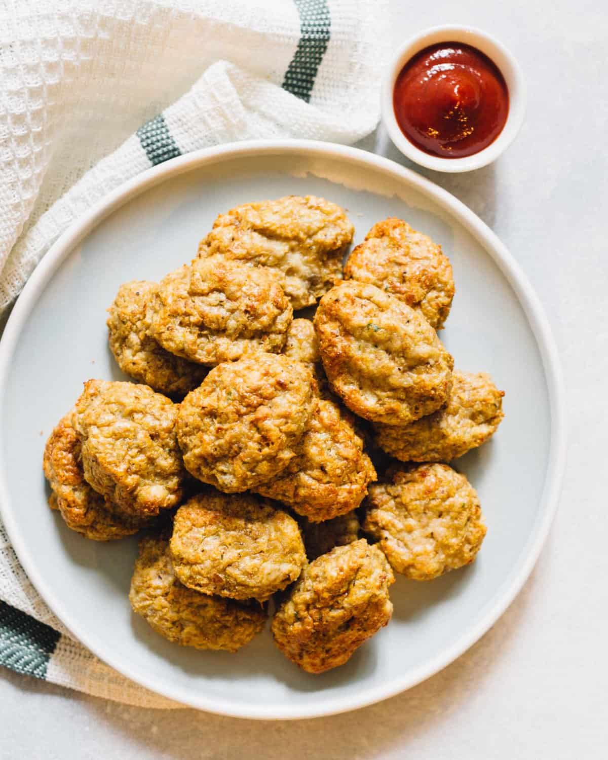 Three ingredients is all you'll need for the easiest three ingredient chicken nugget recipe EVER!! They are awesome for #mealprepping and they make quick weeknight dinners so easy and no stress! #chickenrecipes #chickenugget #mealprep #easymeal #mealpreppingrecipe #makeaheadmeal