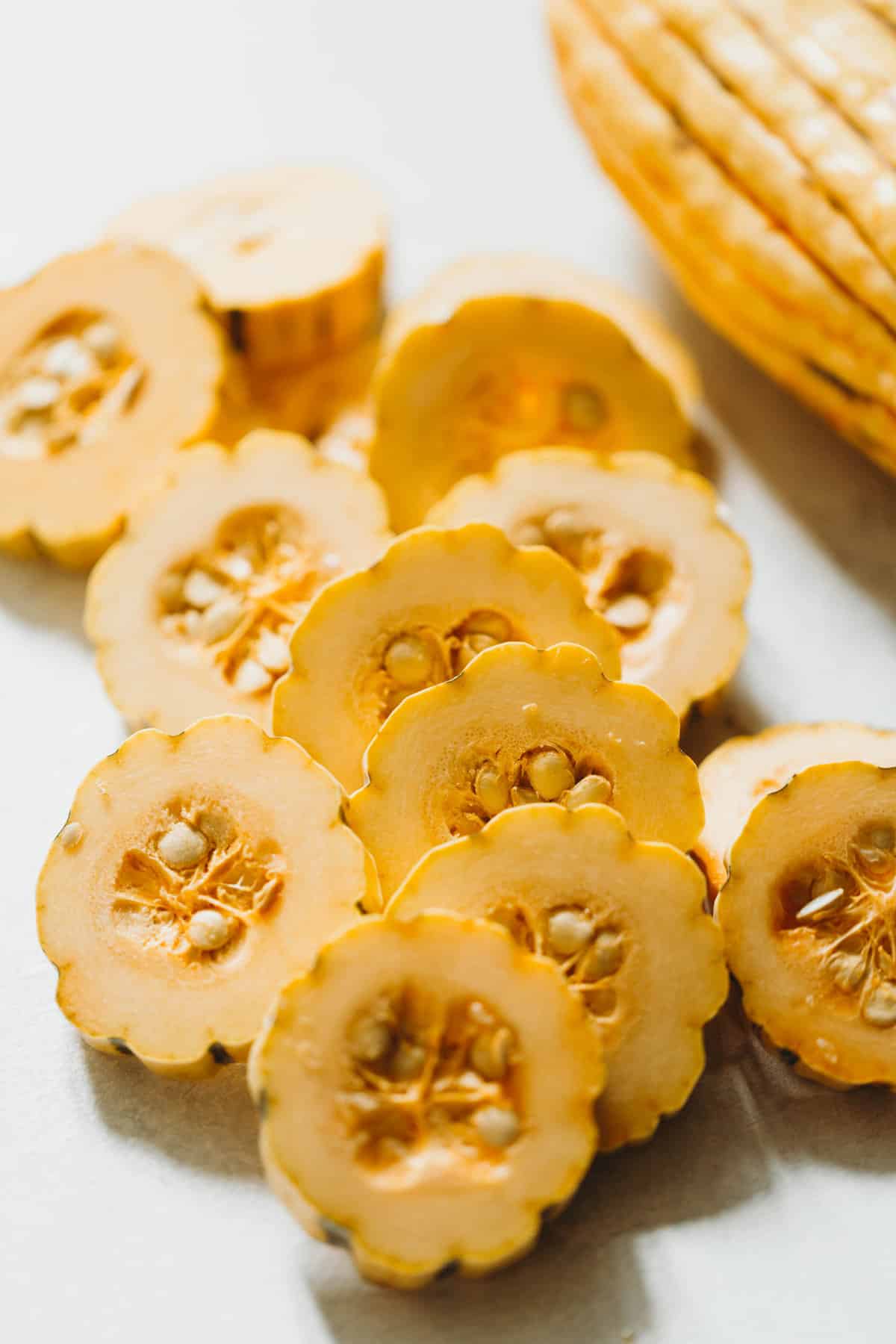 Raw delicata squash slices in pile