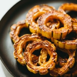 Delicata squash is an easy side dish to make and incredibly sweet like candy! If you've never had it before, now is your time to try this unique and delicious squash! #squash #delicatasquash #squashrecipe #roastedsquash