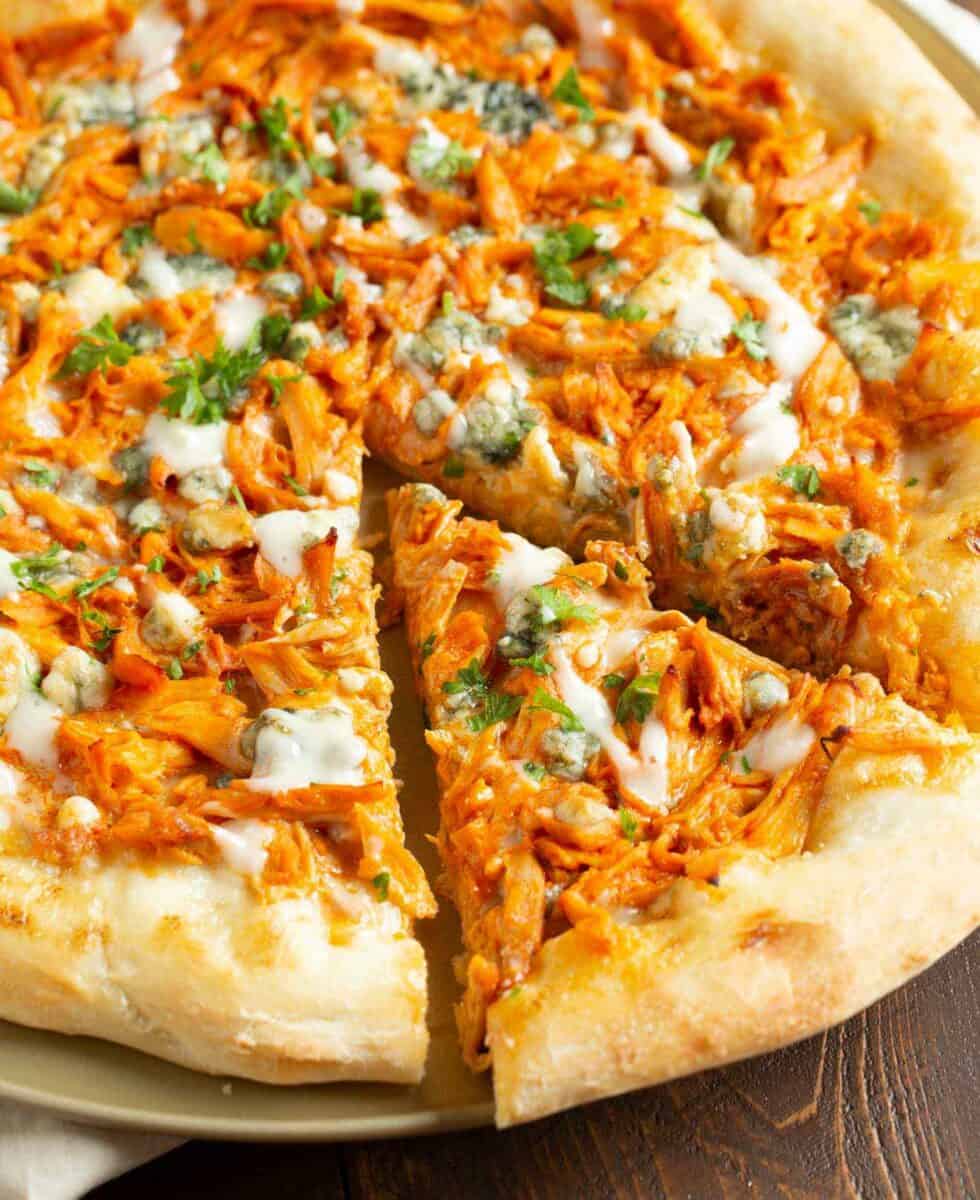 If you love buffalo chicken wings, then you will love this buffalo chicken pizza! The perfect alternative to have during game day if you don't want a bunch of messy hands around! #buffalochicken #pizza #buffalosauce #pizzarecipe