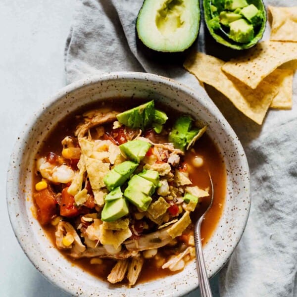 This chicken tortilla soup made on the stovetop is deliciously flavorful and spicy! You'll love how quickly it comes together and all the textures throughout the soup! The broth is SO good you'll be going back for more bowls! #soup #souprecipes #chicken #tortillasoup #chickenrecipes #soupfordinner #dinnerideas