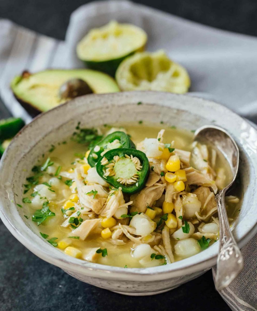 This Instant Pot jalapeño lime chicken soup is beyond flavorful! The spicy broth has hearty additions of hominy, corn, and shredded chicken. Put this all together in less than an hour!