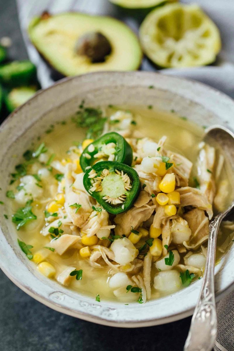 This Instant Pot jalapeño lime chicken soup is beyond flavorful! The spicy broth has hearty additions of hominy, corn, and shredded chicken. Put this all together in less than an hour!