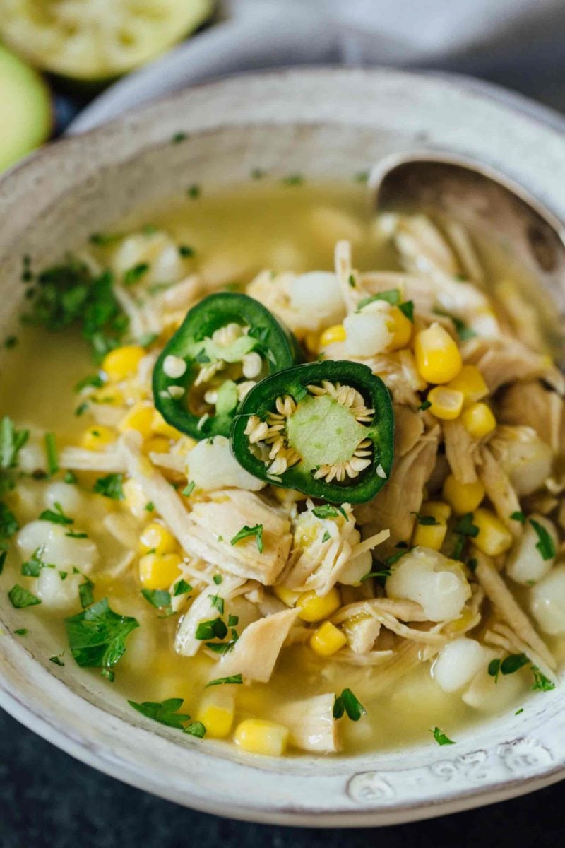 This Instant Pot jalapeño lime chicken soup is beyond flavorful! The spicy broth has hearty additions of hominy, corn, and shredded chicken. Put this all together in less than an hour!