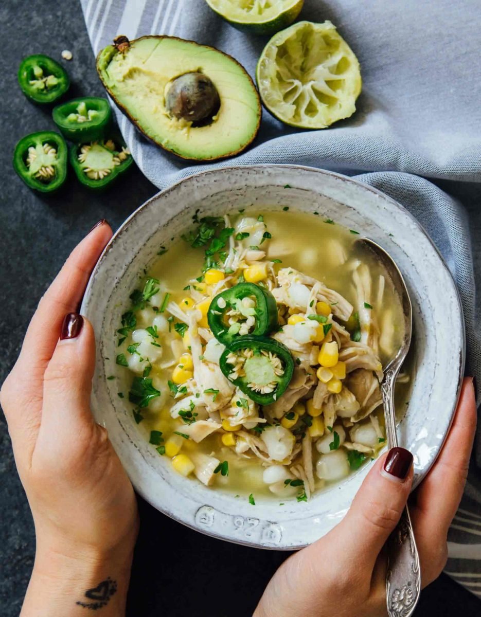 This Instant Pot jalapeño lime chicken soup is beyond flavorful! The spicy broth has hearty additions of hominy, corn, and shredded chicken. Put this all together in less than an hour!