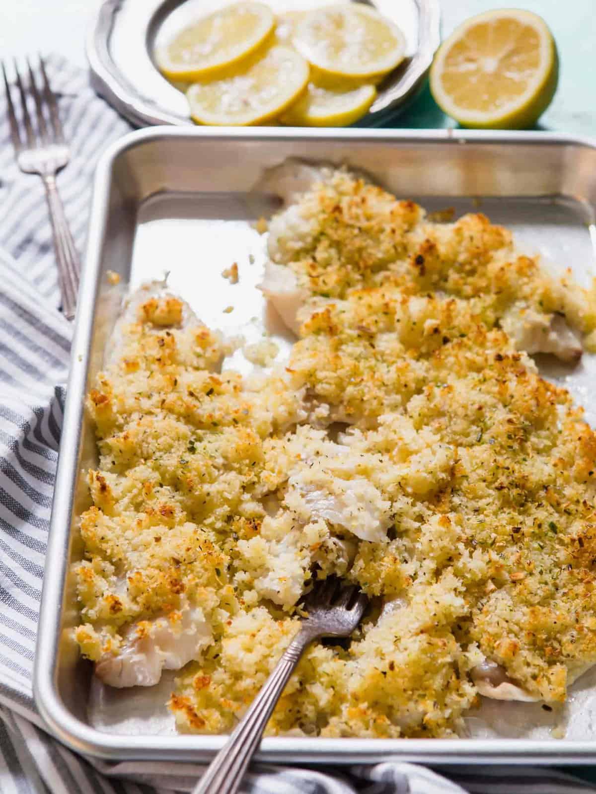 Crispy haddock on baking sheet with fork