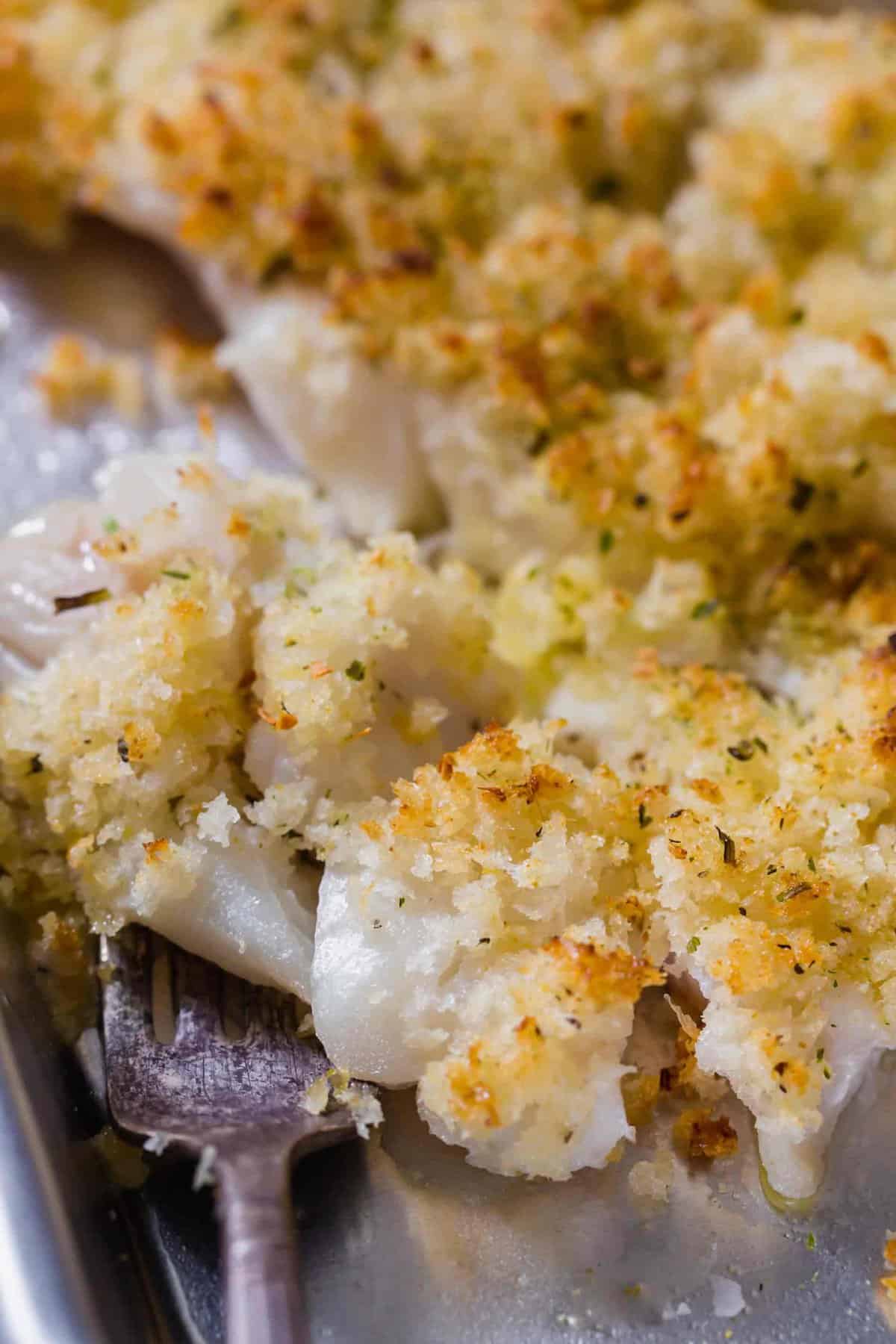 Closeup of flaky, crispy haddock on fork