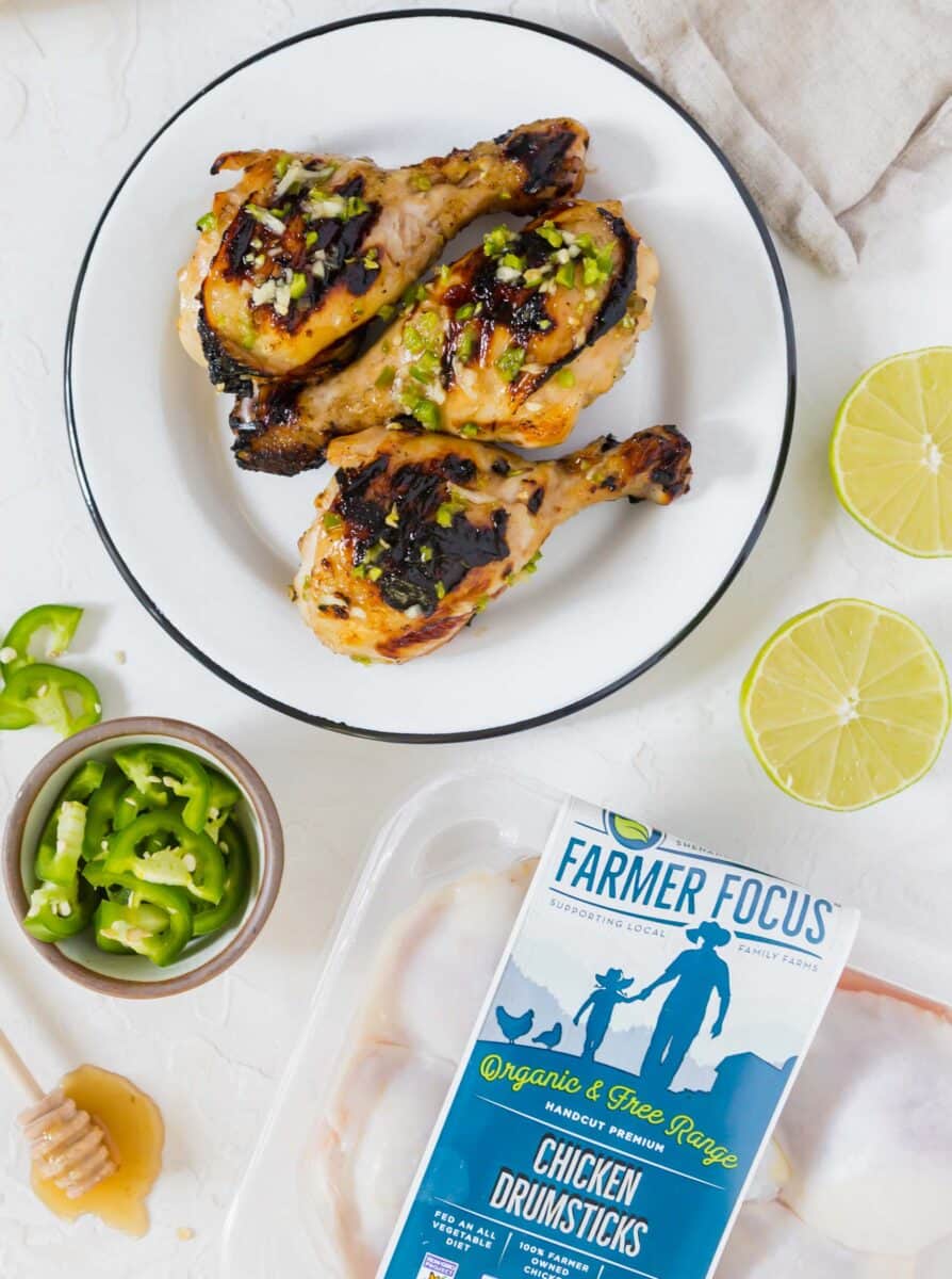 These honey jalapeno grilled chicken drumsticks are an easy sweet and spicy recipe! Made on the outdoor grill, they come together for a quick meal!