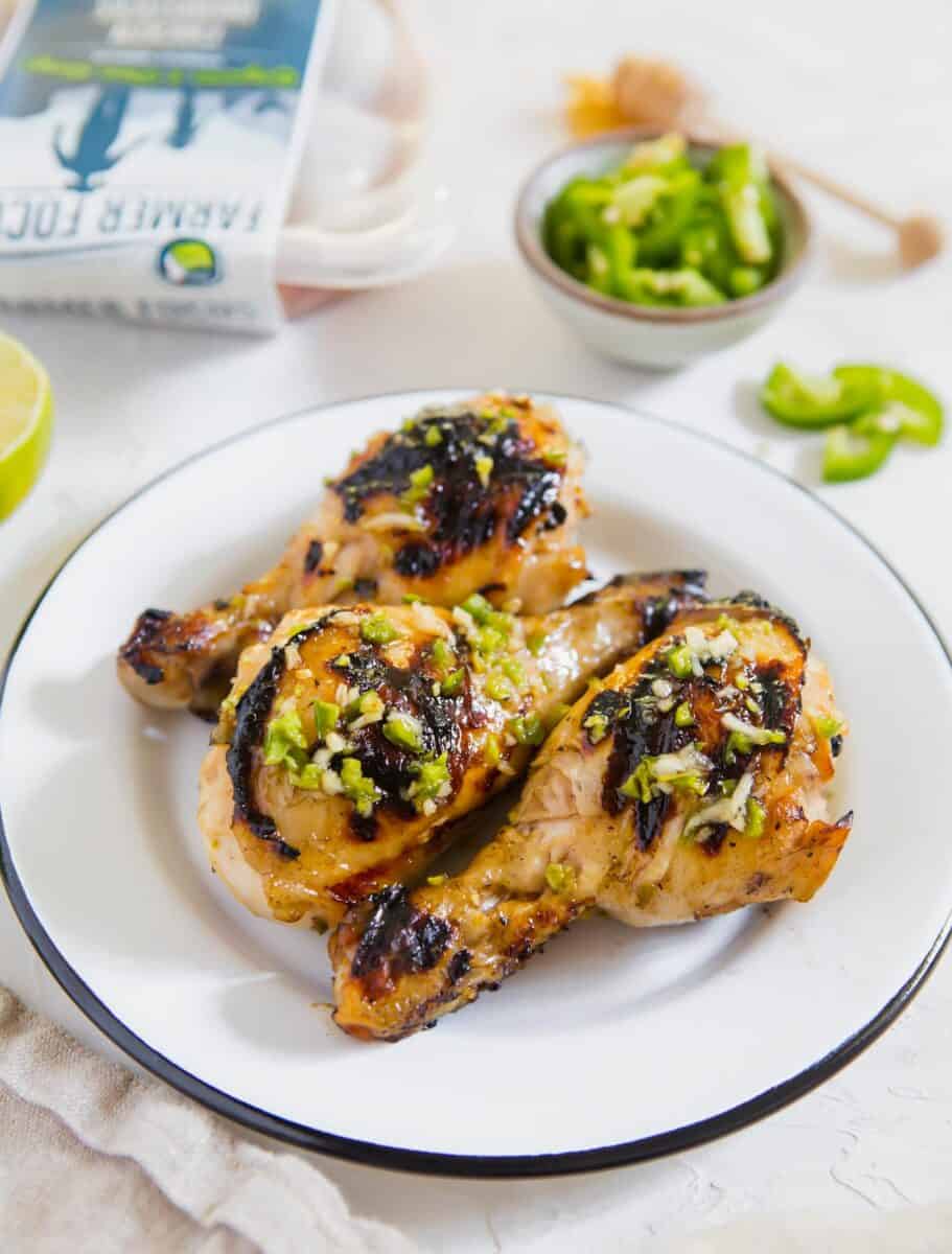 These honey jalapeno grilled chicken drumsticks are an easy sweet and spicy recipe! Made on the outdoor grill, they come together for a quick meal!
