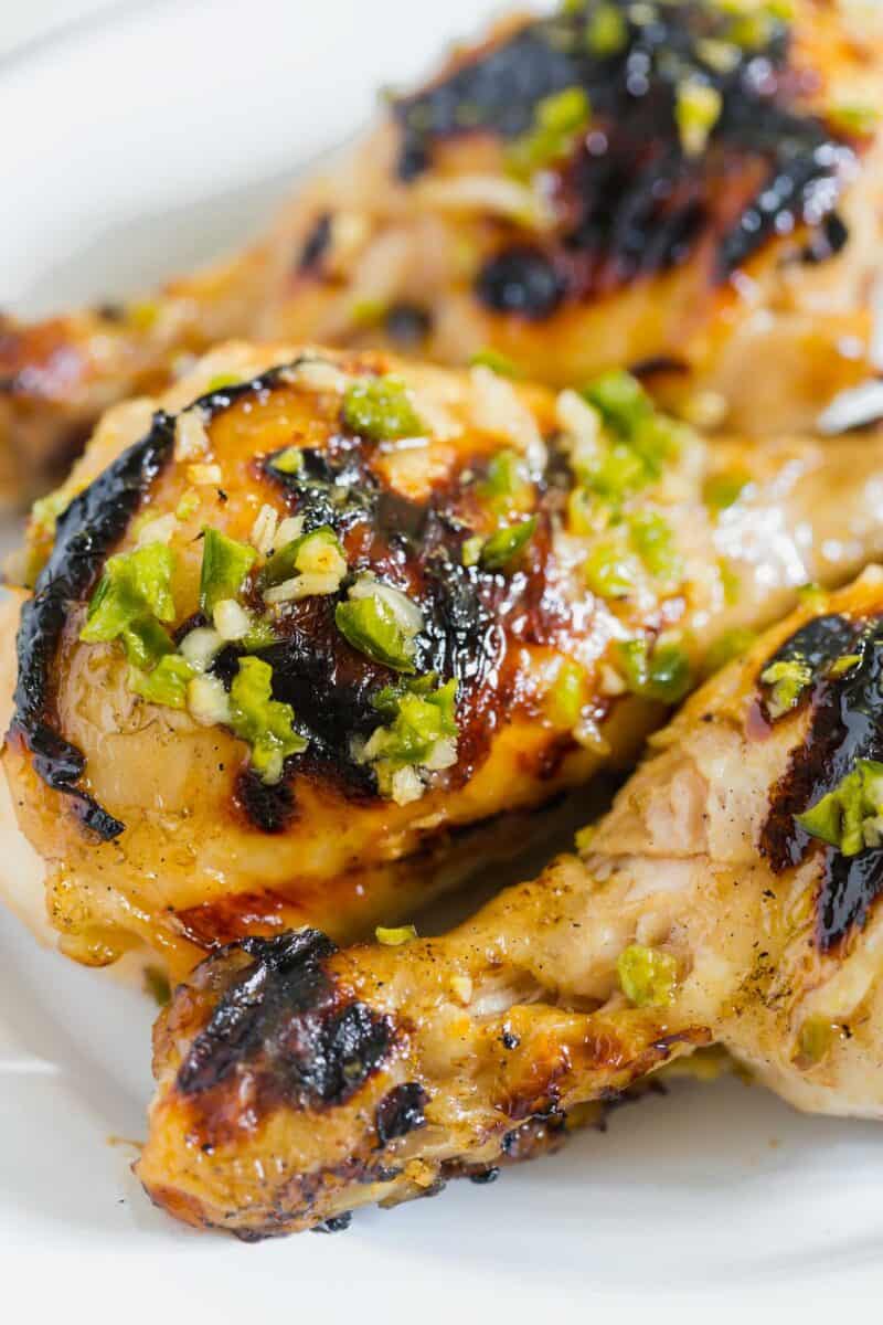 These honey jalapeno grilled chicken drumsticks are an easy sweet and spicy recipe! Made on the outdoor grill, they come together for a quick meal!