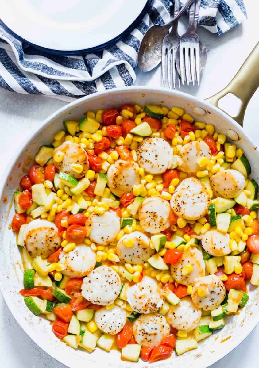 Scallops and summer vegetables make for a quick weeknight meal! Everything comes together super quickly and it's a light and refreshing meal option!