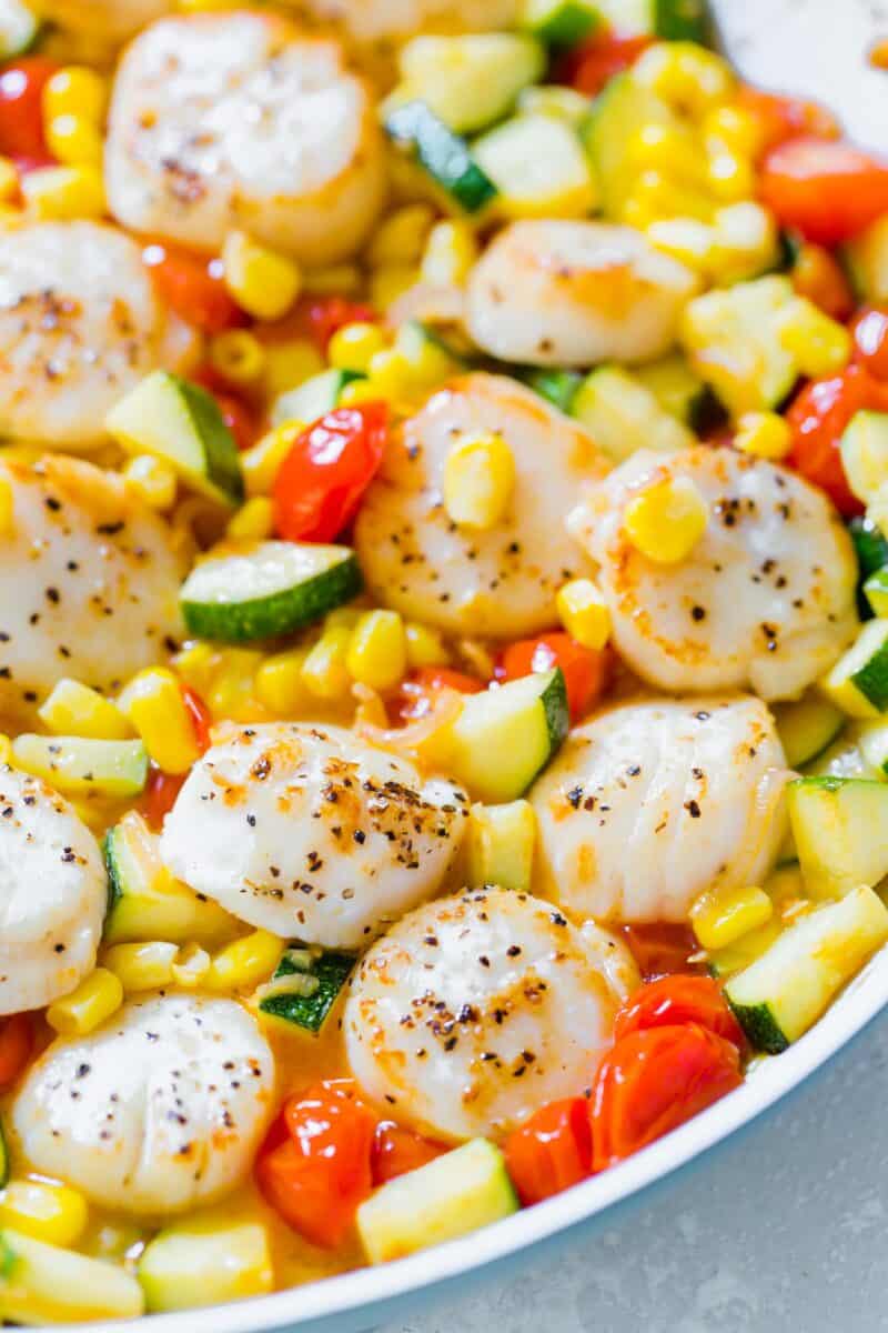 Scallops and summer vegetables make for a quick weeknight meal! Everything comes together super quickly and it's a light and refreshing meal option!