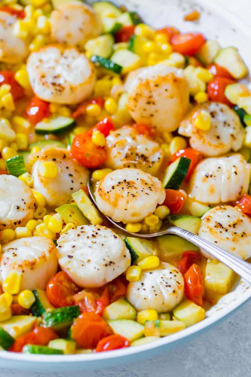 Scallops and summer vegetables make for a quick weeknight meal! Everything comes together super quickly and it's a light and refreshing meal option!