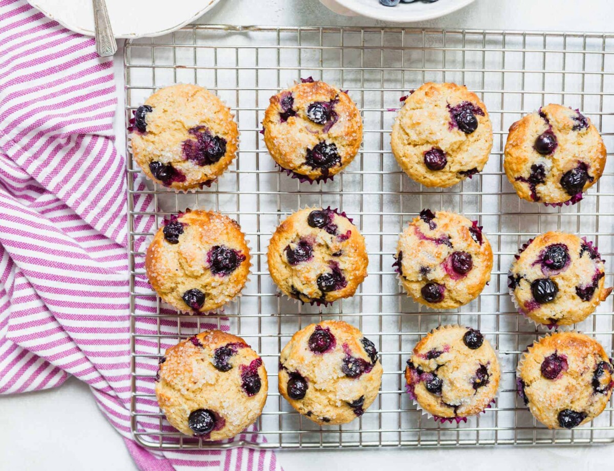 These tender blueberry overload muffins are literally overflowing and FILLED with fresh blueberries! They're so soft, tender, and just like straight out of a bakery!