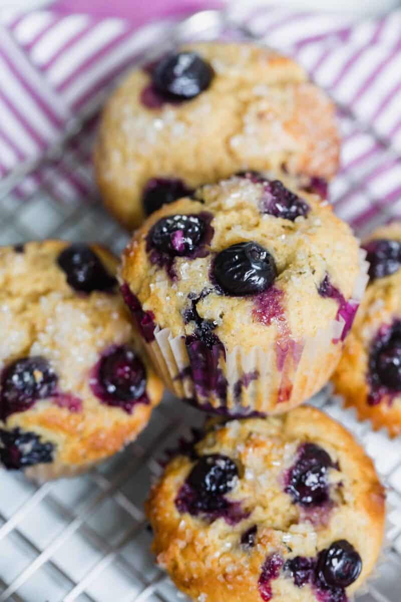 These tender blueberry overload muffins are literally overflowing and FILLED with fresh blueberries! They're so soft, tender, and just like straight out of a bakery!