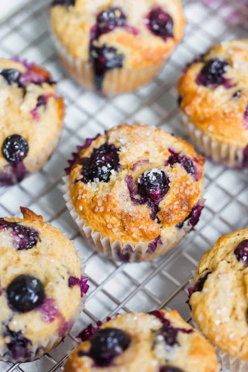 These tender blueberry overload muffins are literally overflowing and FILLED with fresh blueberries! They're so soft, tender, and just like straight out of a bakery!