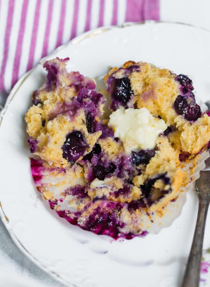 These tender blueberry overload muffins are literally overflowing and FILLED with fresh blueberries! They're so soft, tender, and just like straight out of a bakery!