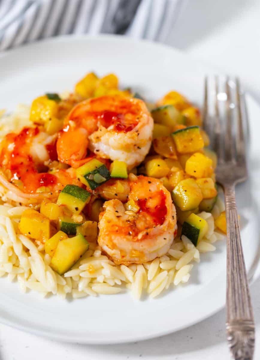 A quick and easy weeknight dinner that features shrimp, zucchini, and orzo! These ingredients are perfect together!