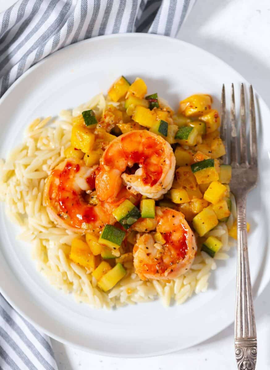 A quick and easy weeknight dinner that features shrimp, zucchini, and orzo! These ingredients are perfect together!