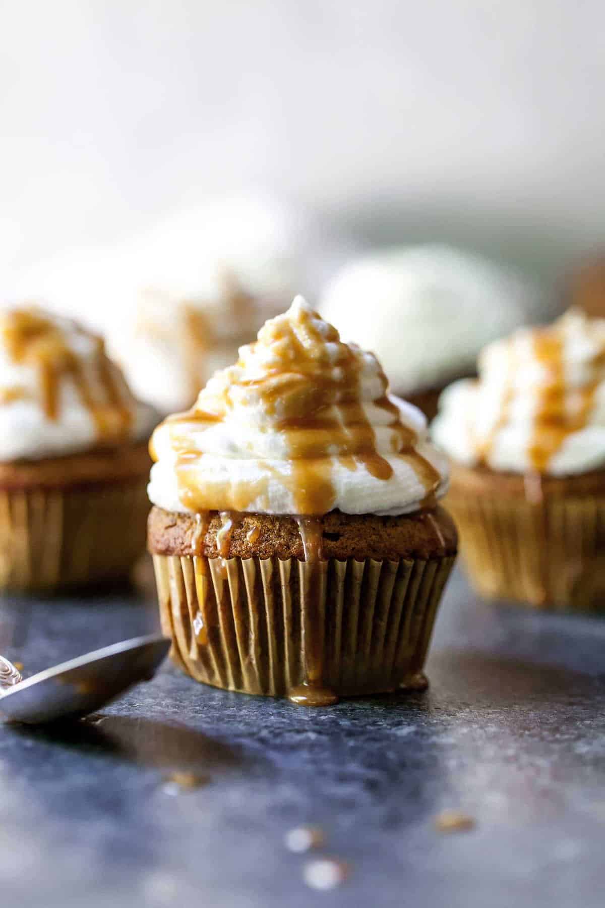 Closeup shot of pumpkin spice latte cupcake with caramel dripping down the sides