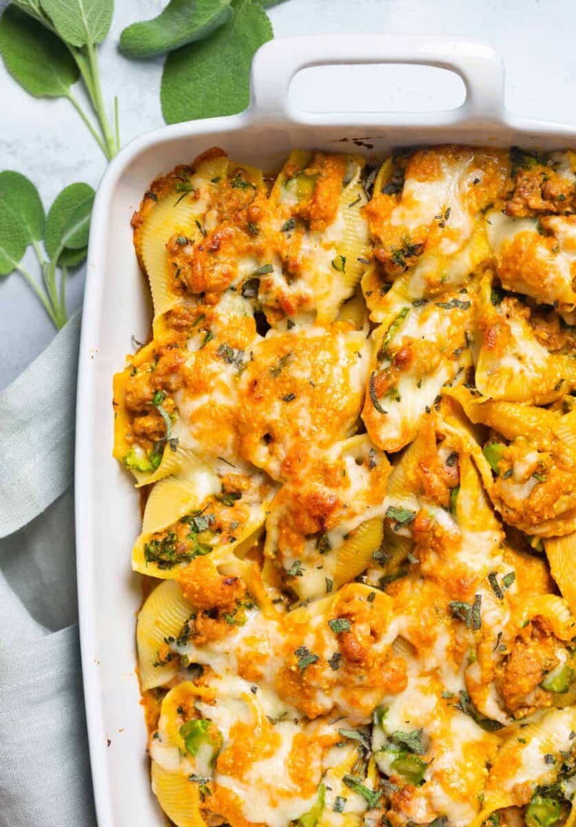 Filled with spicy sausage, broccolini, and a cheesy pumpkin sauce, this pumpkin stuffed shells recipe is the ultimate Fall comfort food!