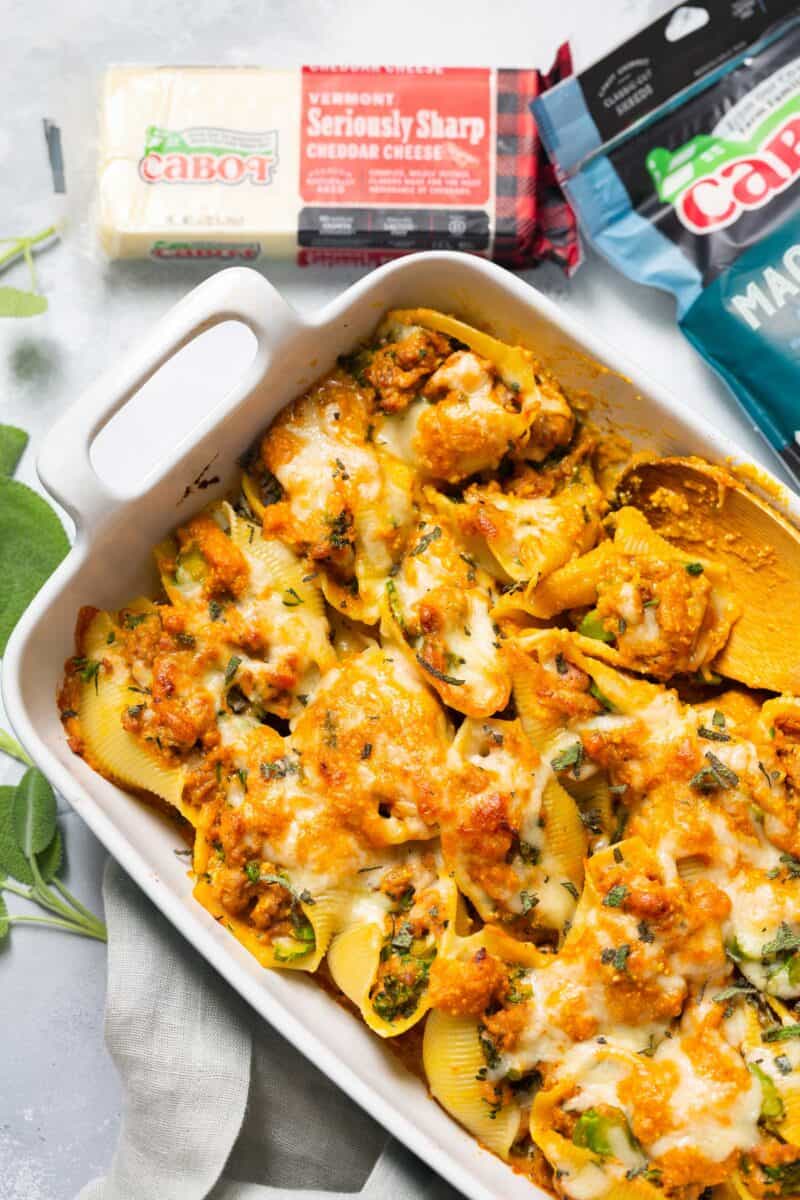 Filled with spicy sausage, broccolini, and a cheesy pumpkin sauce, this pumpkin stuffed shells recipe is the ultimate Fall comfort food!