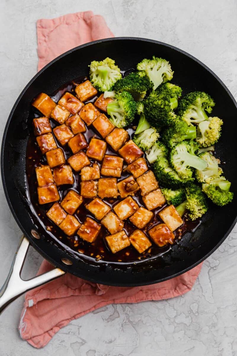 Cubes of tofu and broccoli in a frying pan