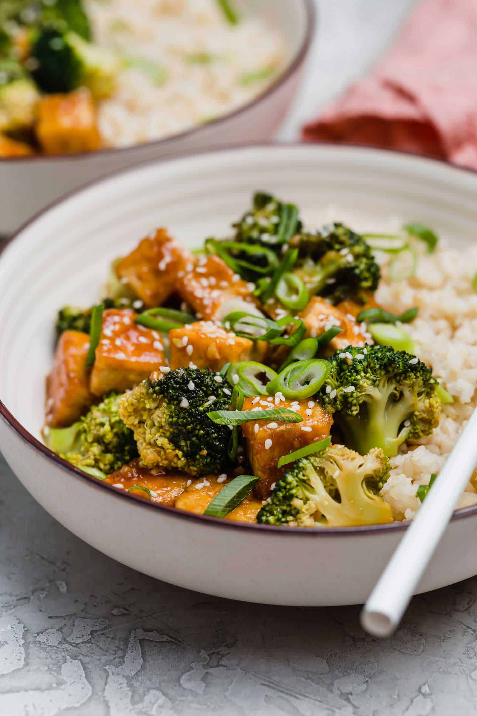 Close up of a teriyaki tofu and broccoli bowl.