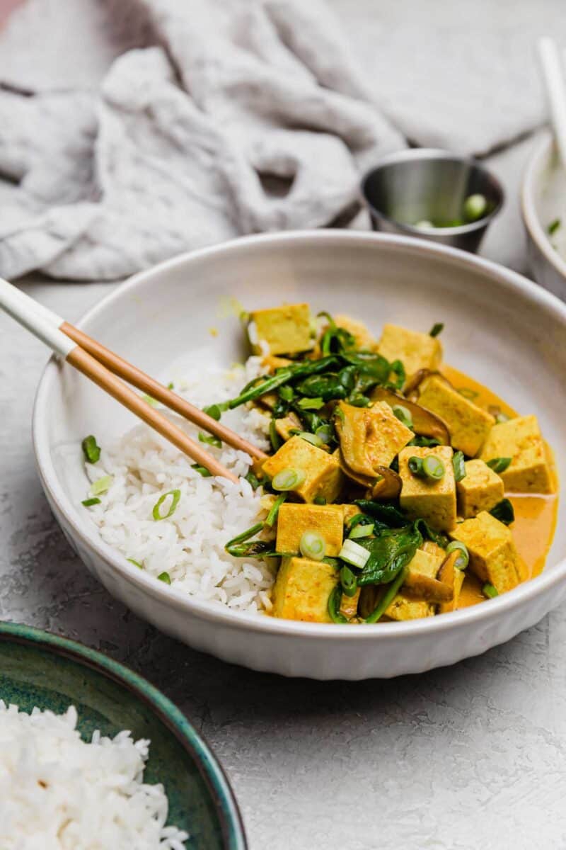 This tofu coconut curry bowl is simmered in a deliciously warm coconut curry sauce along with shiitake mushrooms. A plant-based dinner for any evening!