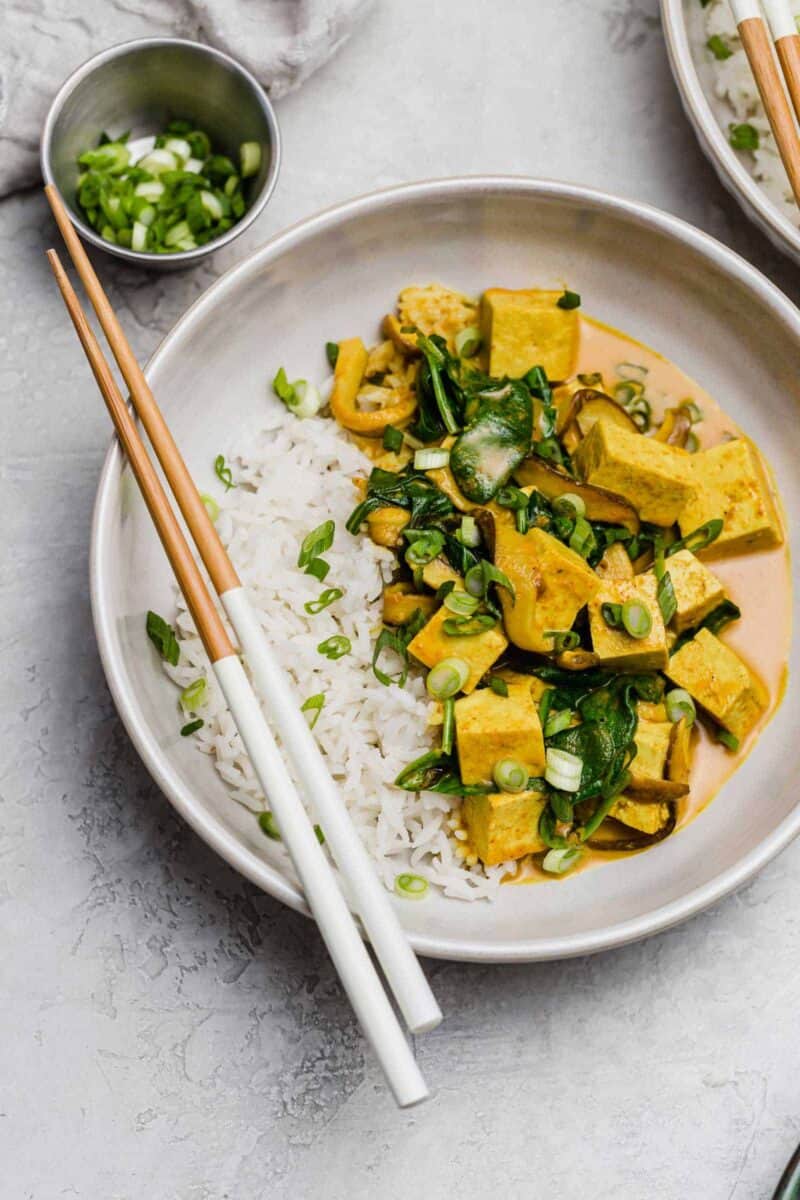 This tofu coconut curry bowl is simmered in a deliciously warm coconut curry sauce along with shiitake mushrooms. A plant-based dinner for any evening!