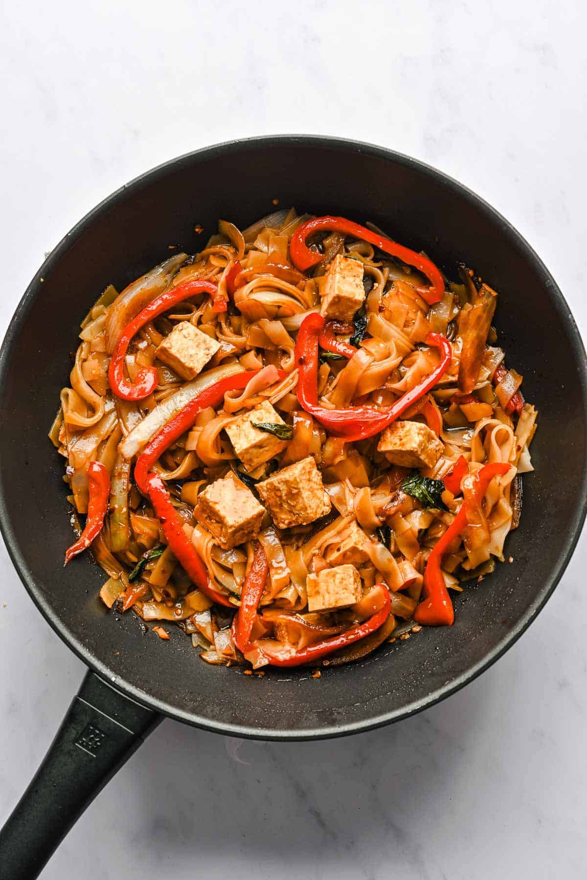 Drunken noodles in a wok.