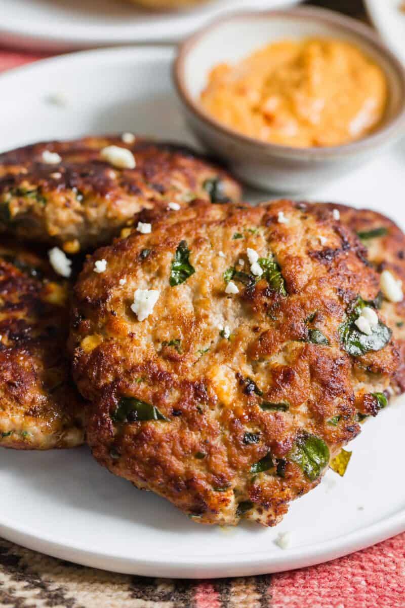 Turkey spinach and feta burgers are an excellent way to use up ground turkey in a flavorful Mediterranean-style burger! These egg-free burger patties are the perfect grilling season recipe!