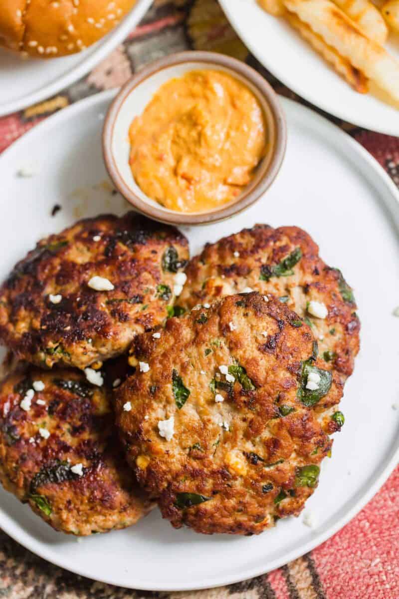 Turkey spinach and feta burgers are an excellent way to use up ground turkey in a flavorful Mediterranean-style burger! These egg-free burger patties are the perfect grilling season recipe!
