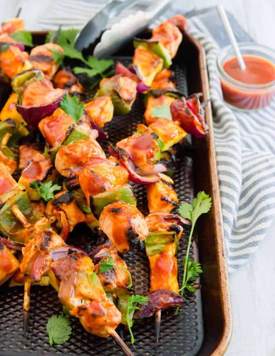 Grilled pineapple bbq chicken kabobs are the perfect summer grilling meal! A deliciously sweet and tangy BBQ sauce is slathered all over these chicken kabobs!