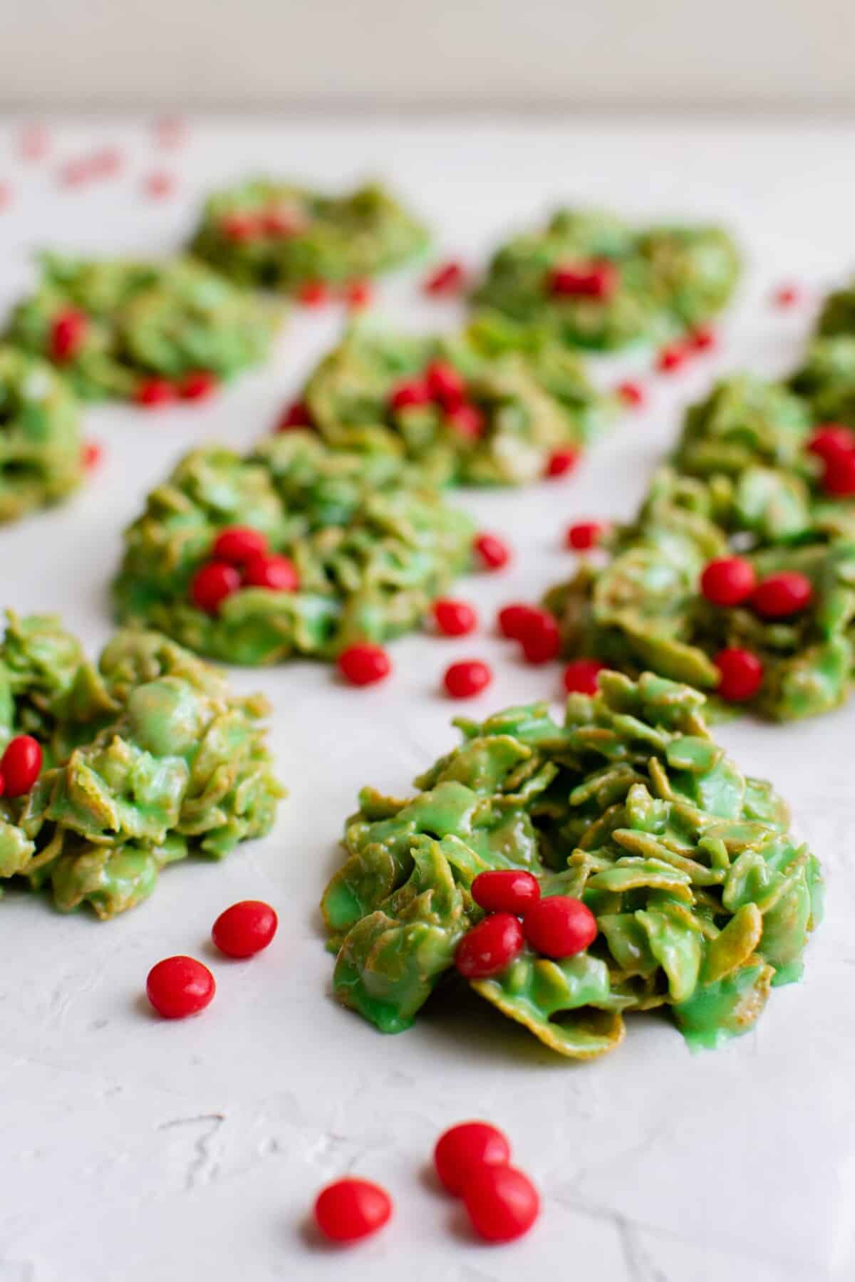 red hots are scattered across a batch of wreaths