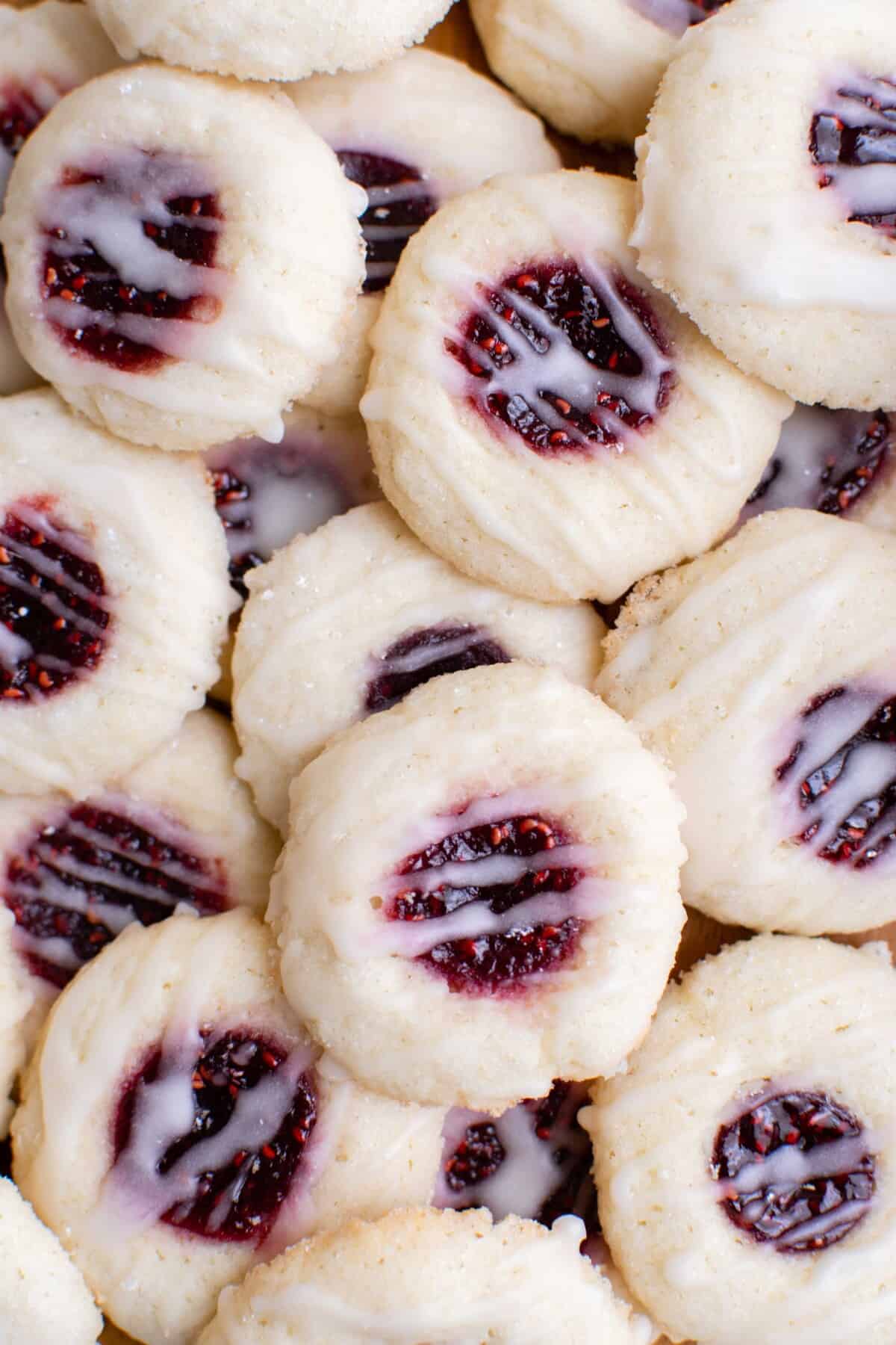 raspberry thumbprint cookies stacked on top of one another